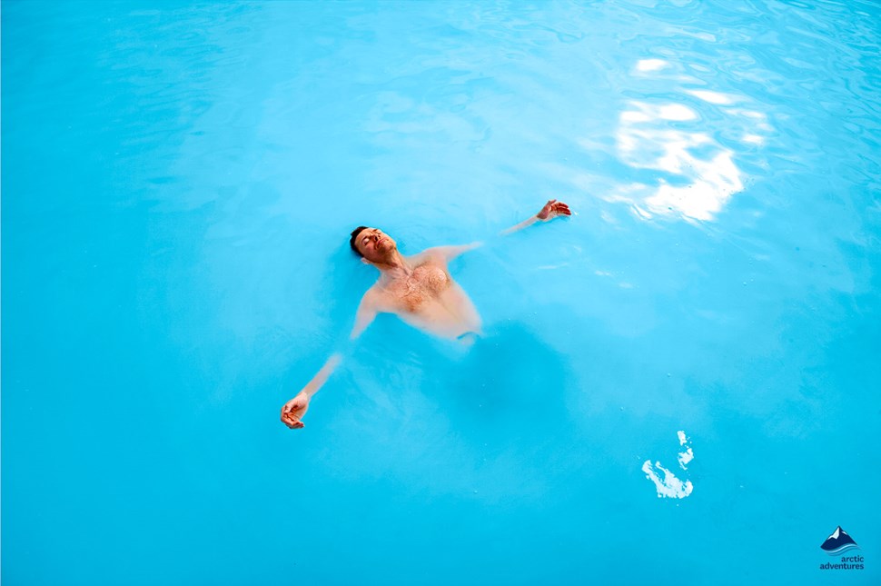 man relaxing in the blue lagoon