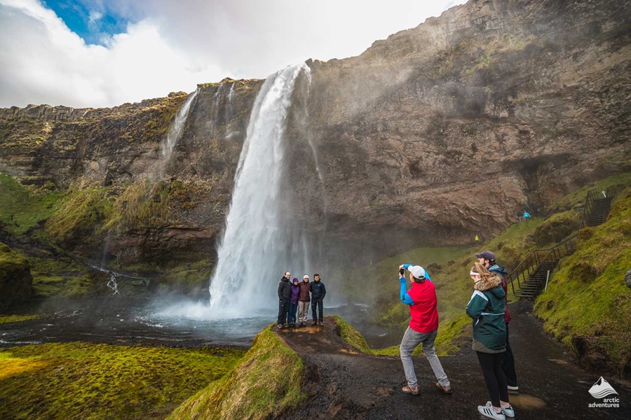 tourists by Seljalandsfoss Waterfall
