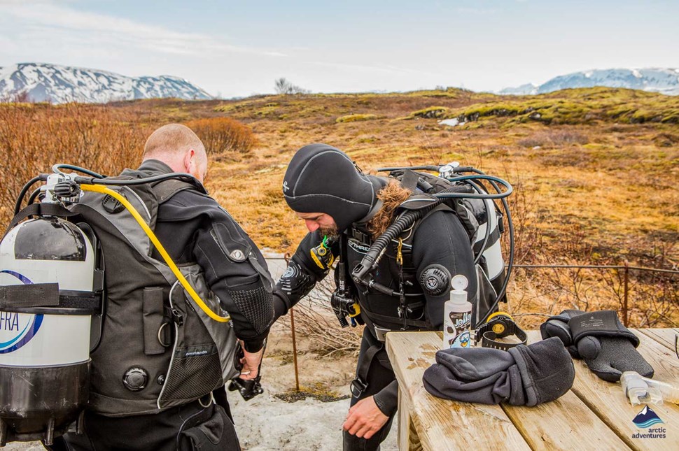 people putting gear for diving at Silfra