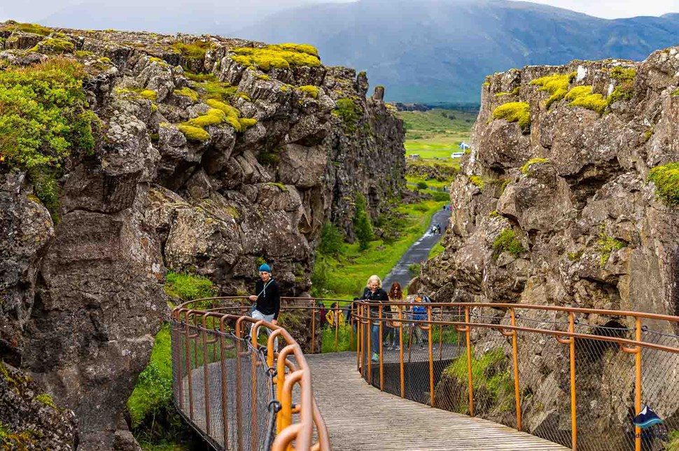 people crossing bridge at Thingvellir National Park