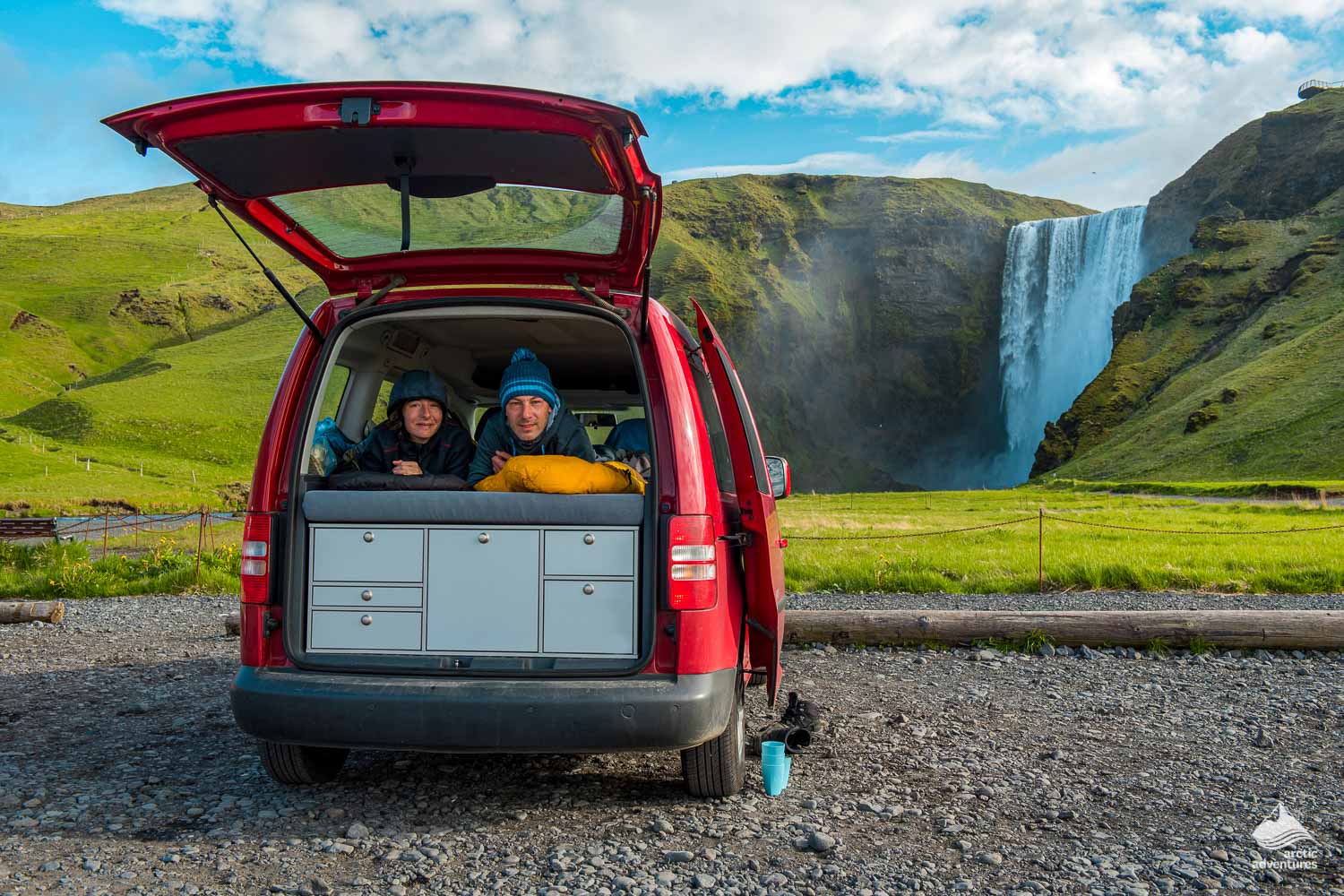 couple camping in van near Skogafoss Waterfall