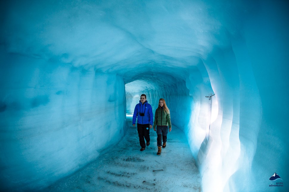 Couple inside man made ice cave in iceland