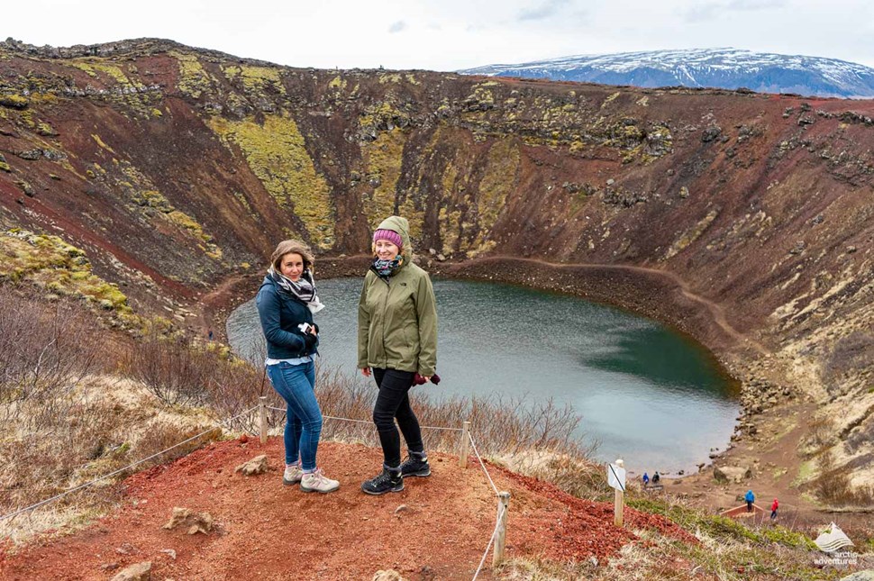 Women standing near Kerid Volcano Crater in Iceland