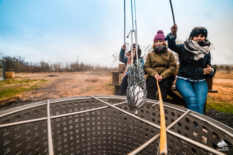 Women boiling eggs in Hveragerdi geothermal pool