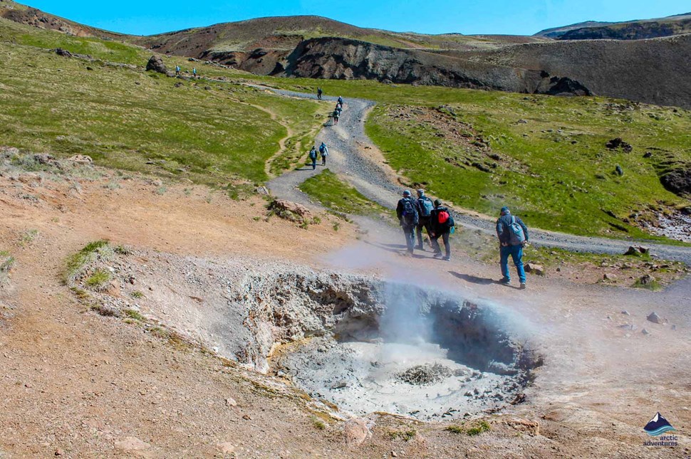 Tourists hiking in valley of Reykjadalur