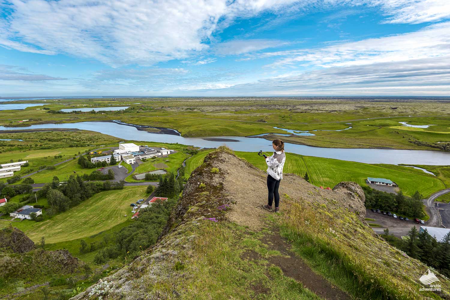 Woman taking pictures of Kirkjubæjarklaustur village