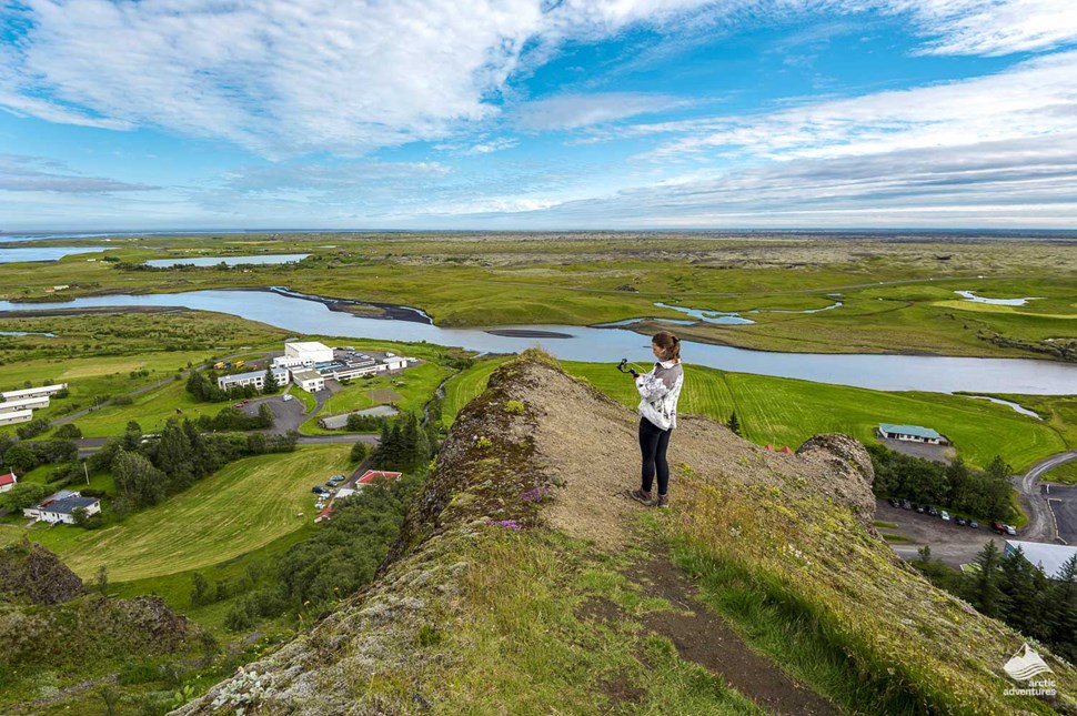 Woman taking pictures of Kirkjubæjarklaustur village