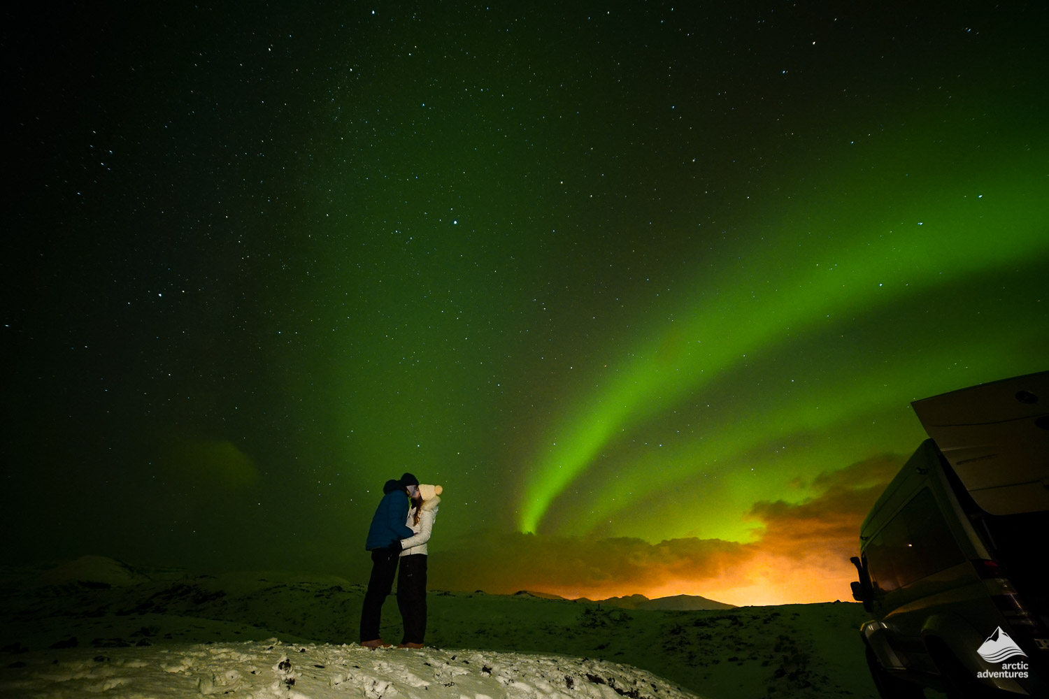 Couple kissing under Northern Lights