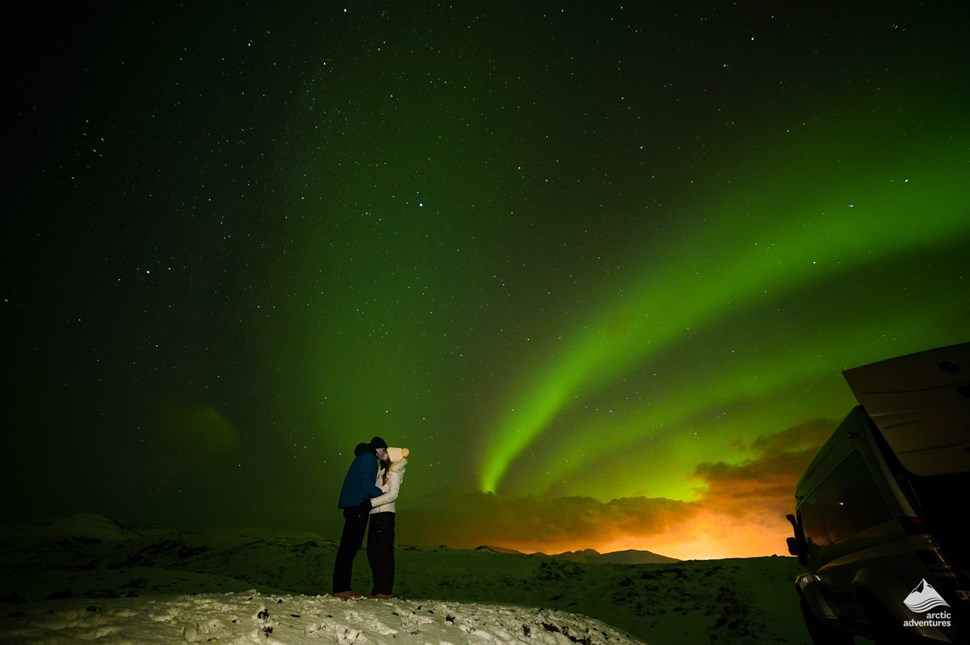Couple kissing under Northern Lights
