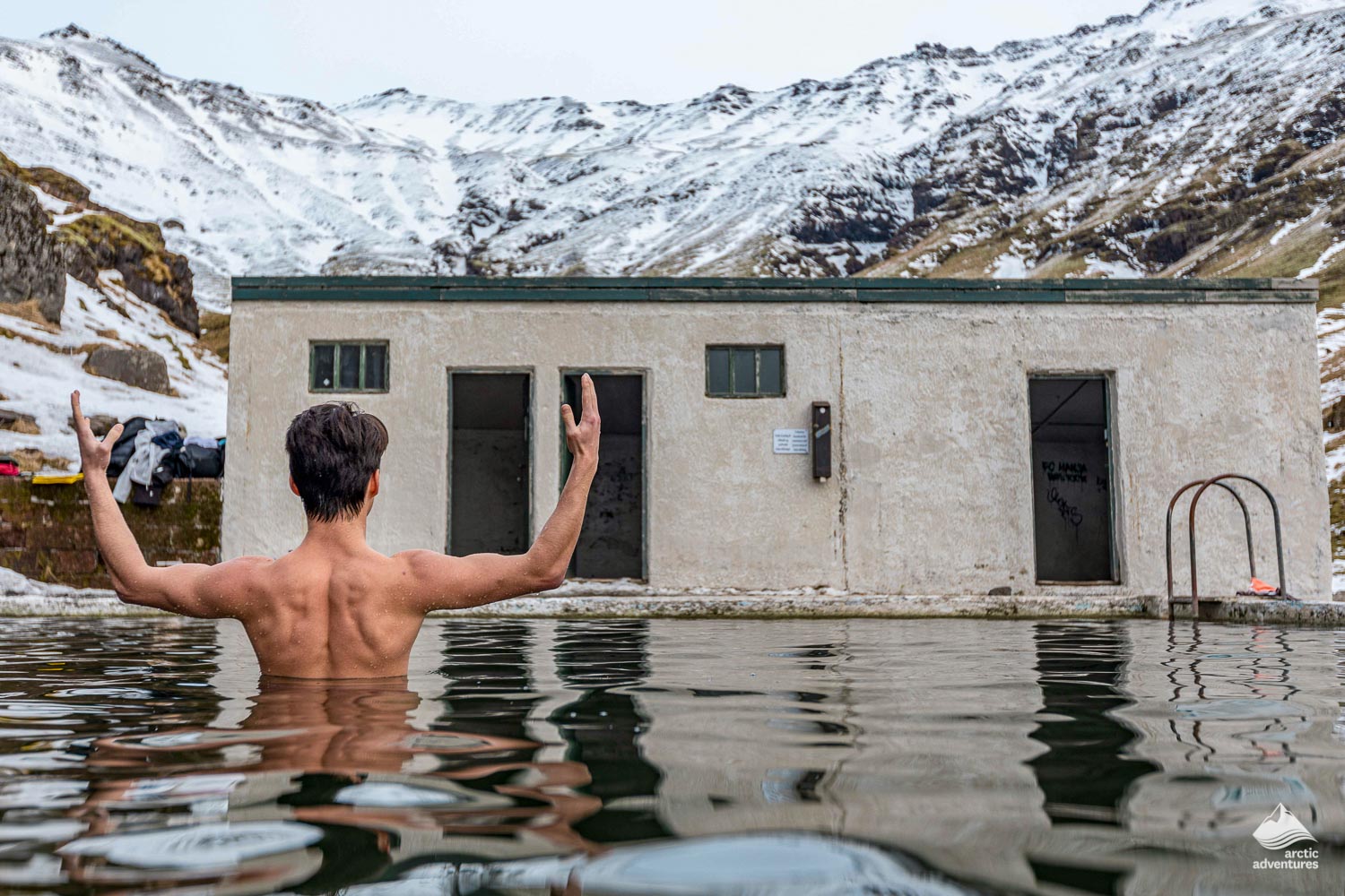 Man relaxing in Seljavallalaug geothermal Pool