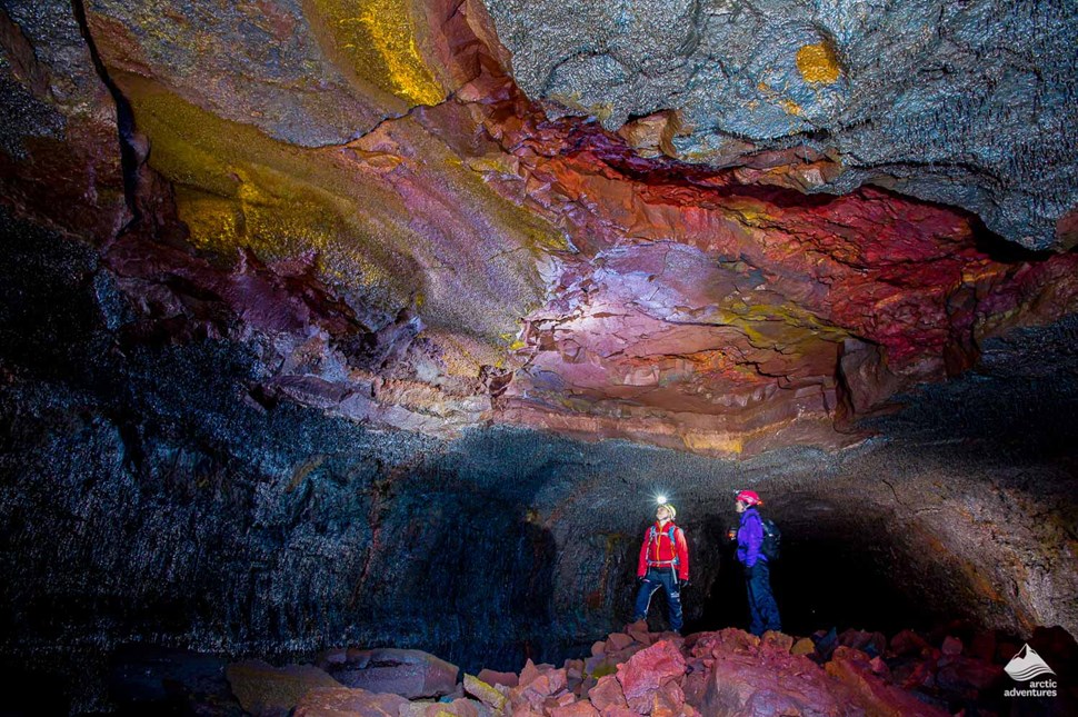 People inside Vidgelmir Lava Cave in Iceland