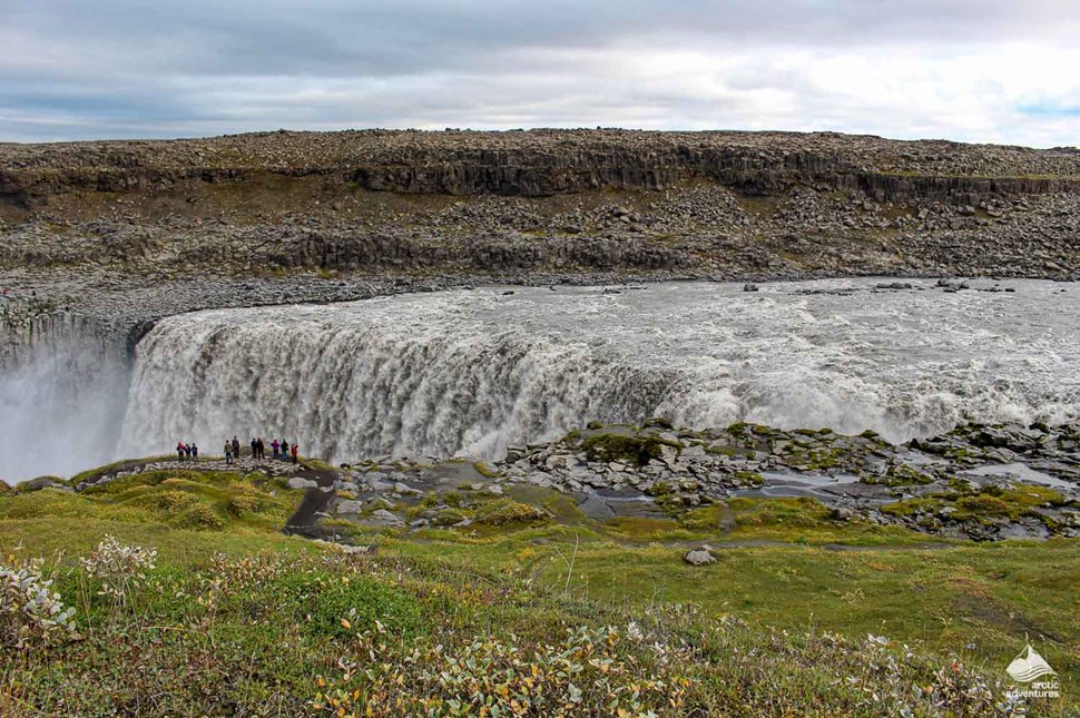 people standing near Dettifoss Waterfall in Iceland