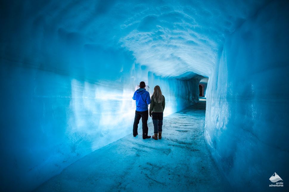 couple in the glacier cave made by man