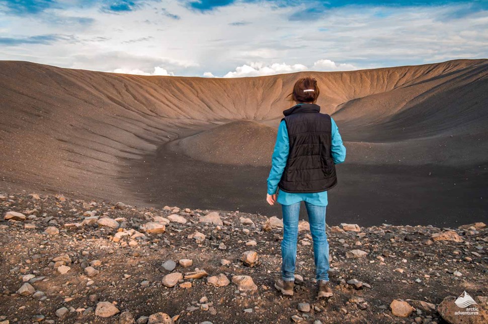 woman looking at Hverfjall Volcano crater in Iceland