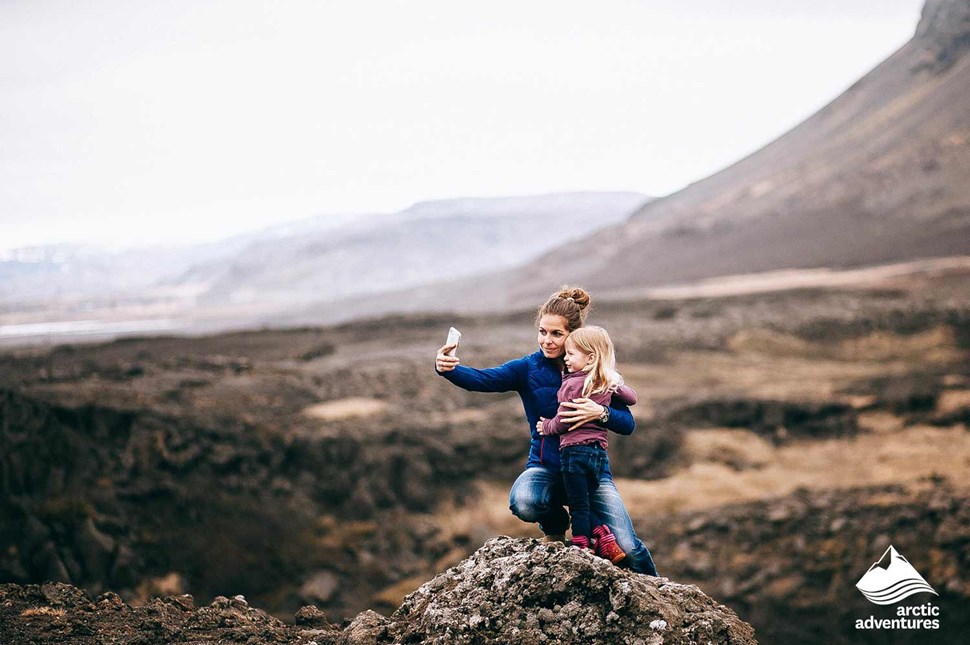 Mom and Daughter taking a picture in mountains