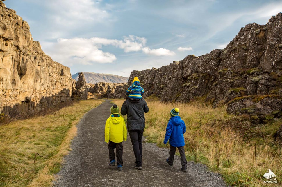 Family exploring Thingvellir National park in Iceland