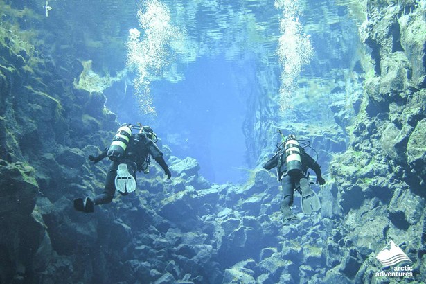 two People Diving in bright blue water