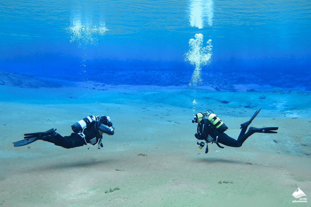 Divers at the bottom of lake