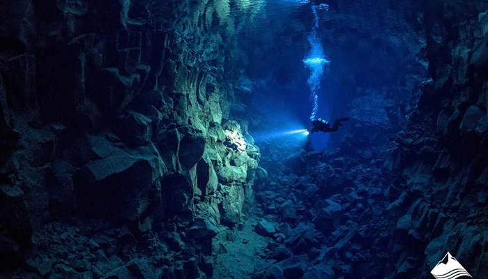 Diver Diving in Cavern lake Iceland