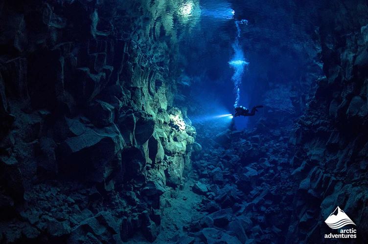 Diver Diving in Cavern lake Diver Diving in Cavern lake Iceland