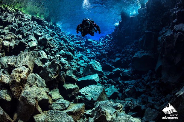 Diving by rocky bottom In Silfra Fissure