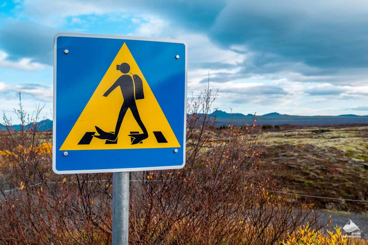 Crossing the road sign with a diver with all the equipment on