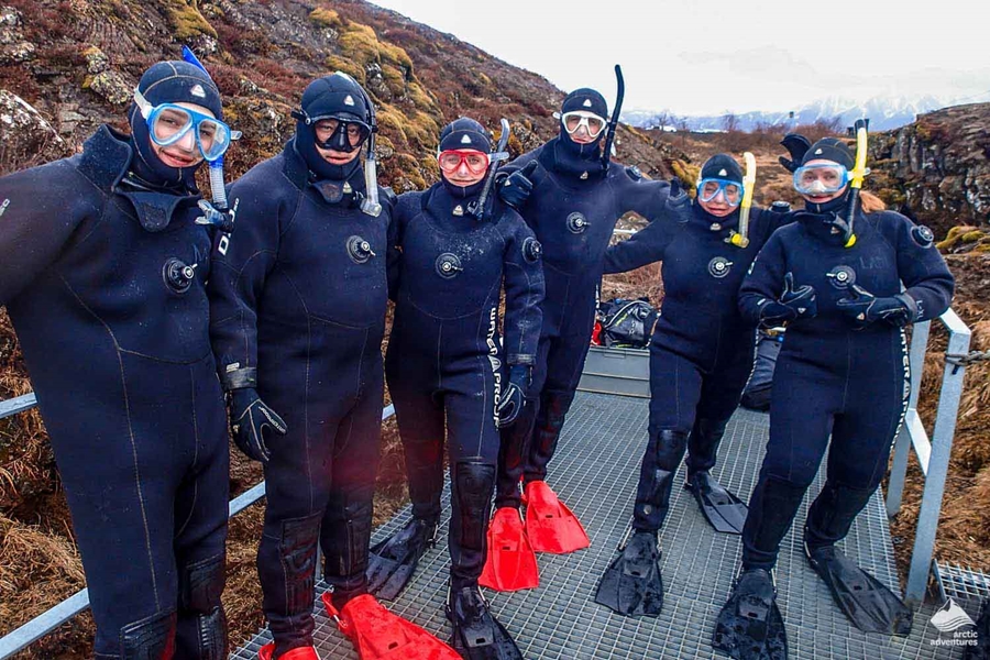 Group of people ready to dive with dry suits on