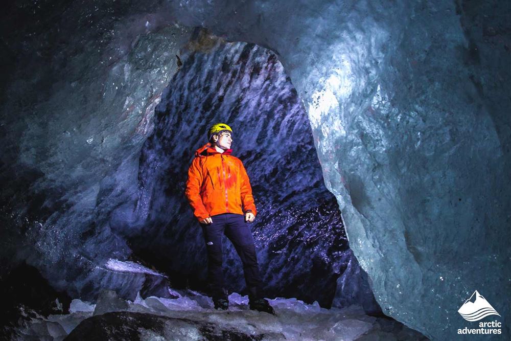 man inside ice cave of Falljokull