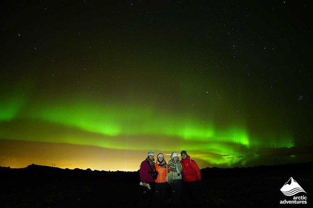 Happy Family Watching Northern Lights in Iceland