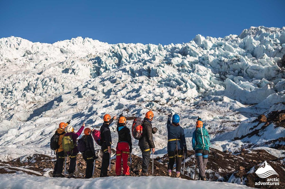 explorers looking at glacier ice crevasses