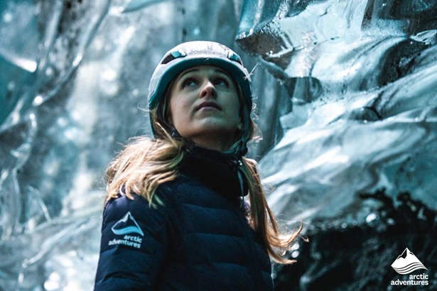 woman inside of crystal clear ice cave