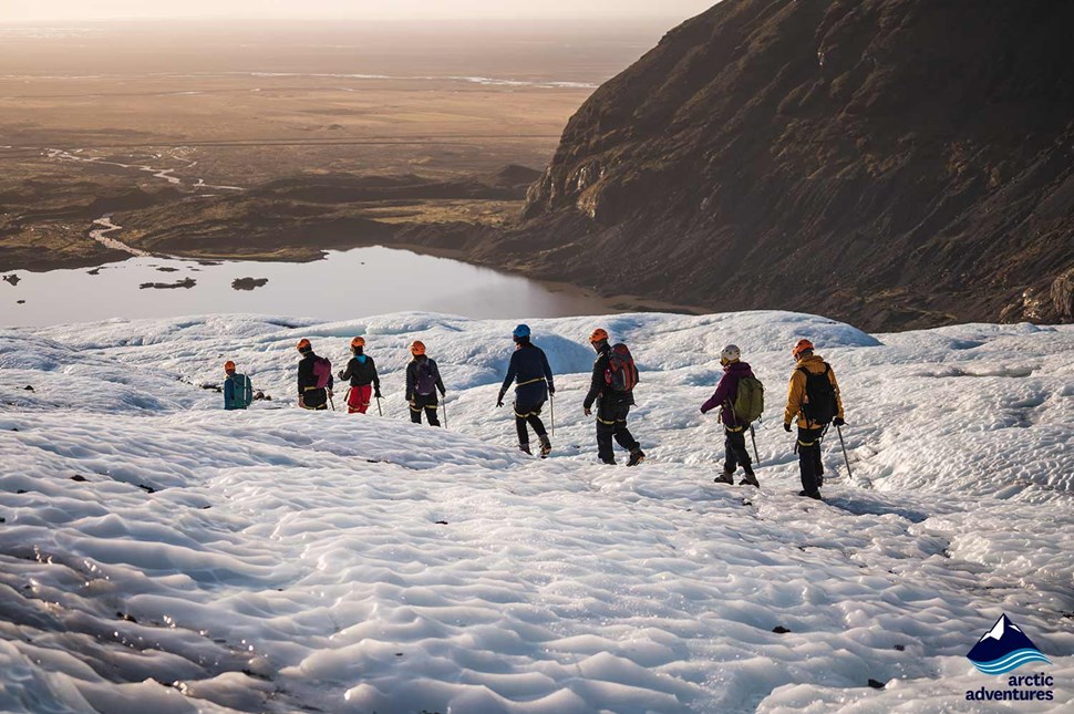 people hiking down the Falljokull Glacier