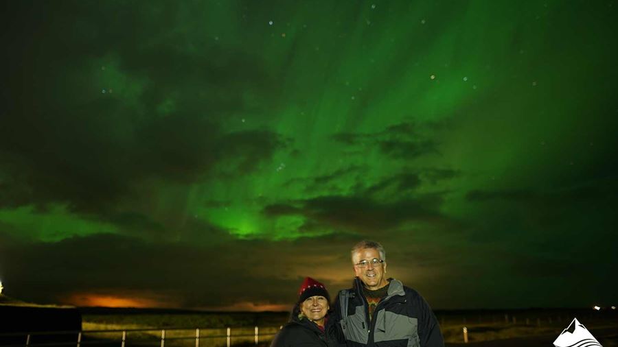 excited couple watching Aurora