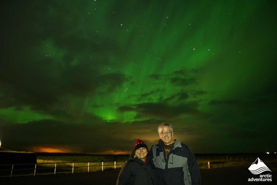 excited couple watching Aurora