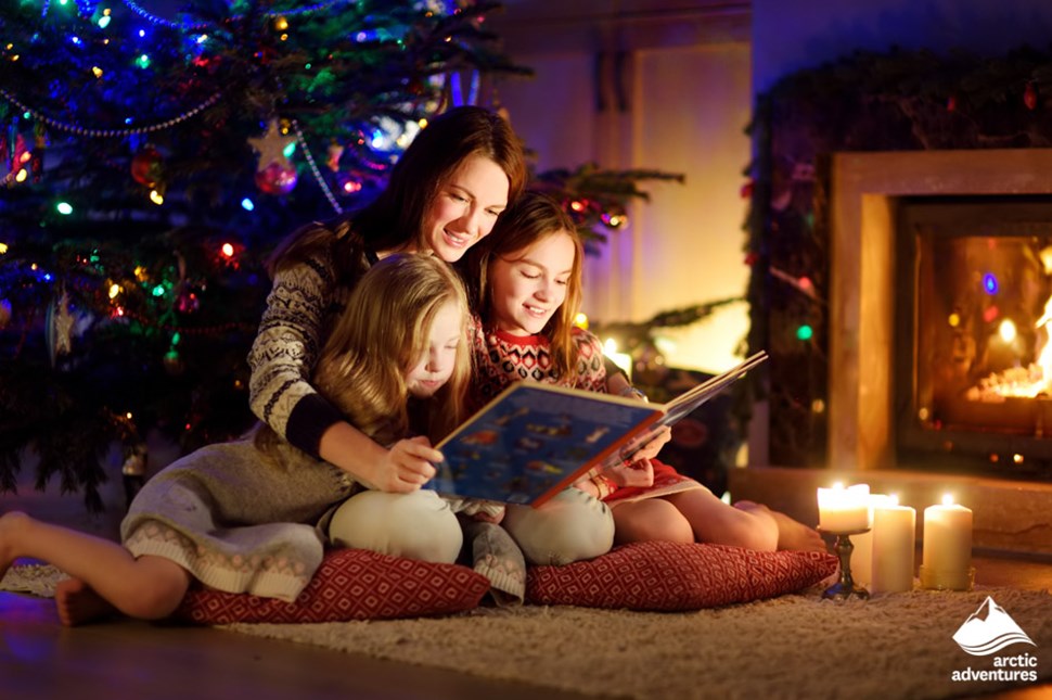 family reading book together on Christmas