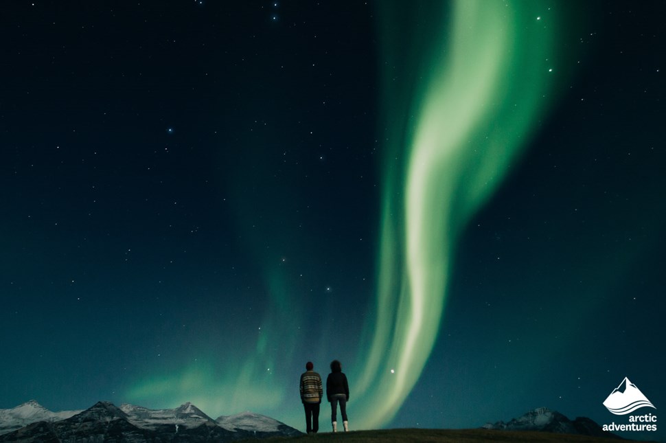 couple watching northern lights in Iceland