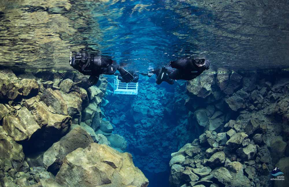 Snorkeling tour in clear water of Silfra Fissure, Iceland.