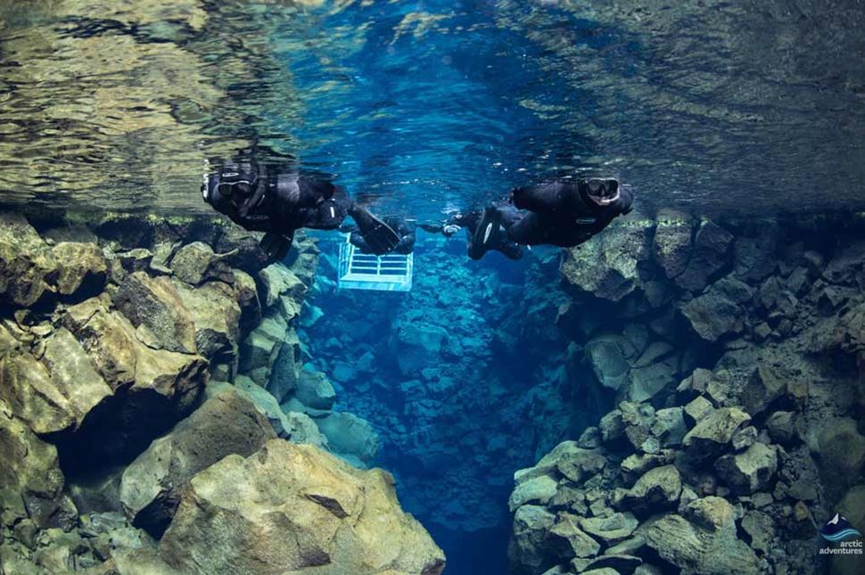 Snorkeling tour in clear water of Silfra Fissure, Iceland.
