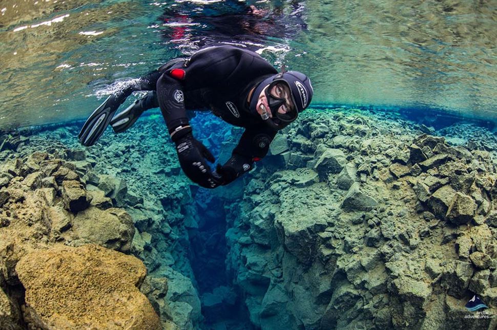 Snorkeler enjoying tour at Silfra Fissure in Iceland.