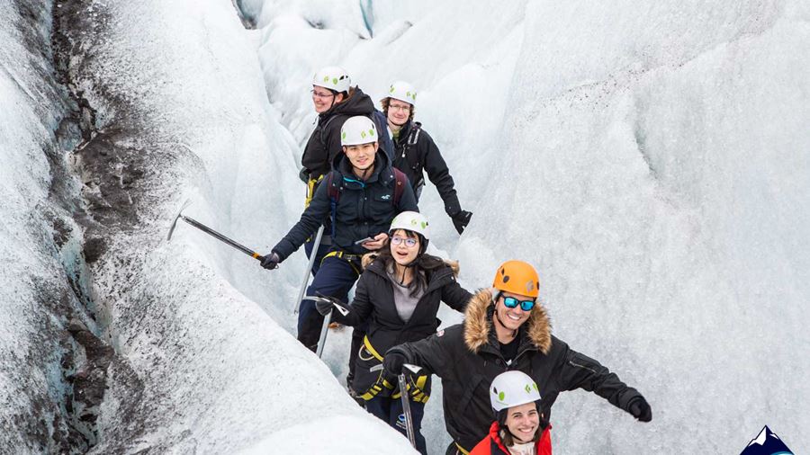 Happy group walking in ice crevasse