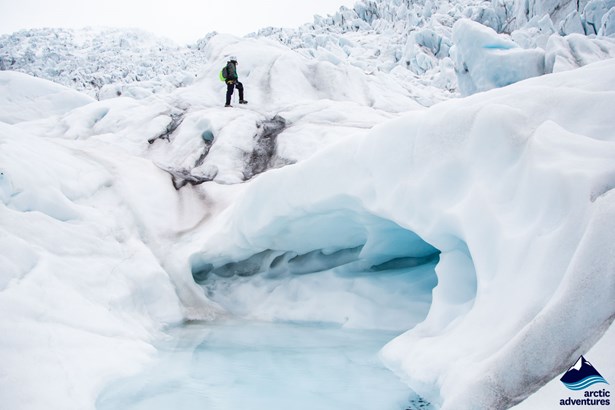 Woman walking by ice caves on Glacier