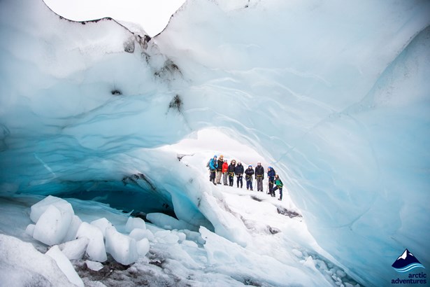 Group looking through the ice cave on glacier