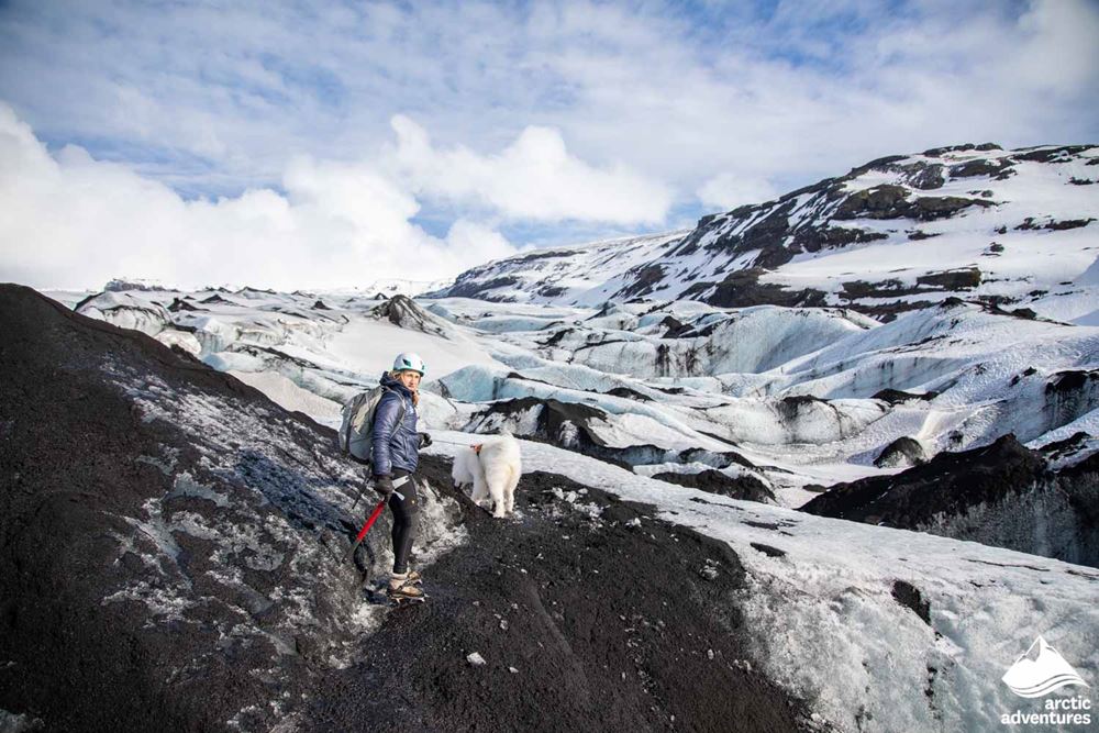 Woman with dog on a glacier