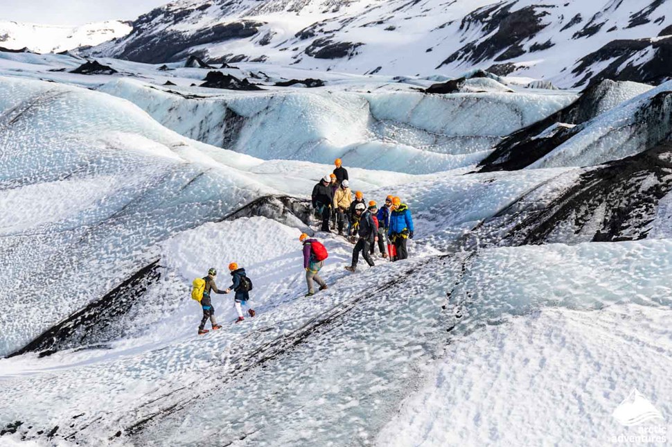 People having guided glacier hike in Iceland