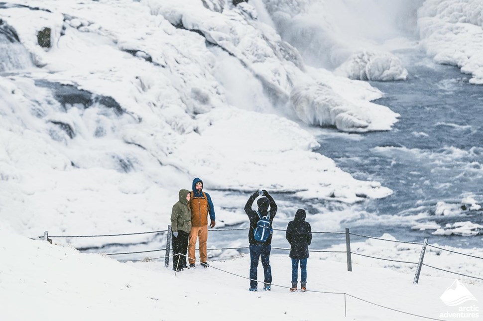 People posing for picture near Gullfoss waterfall
