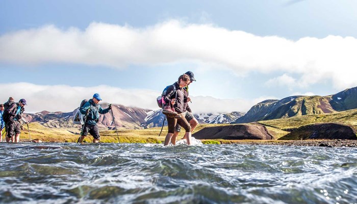 Small Group Crossing River by Foot in Iceland