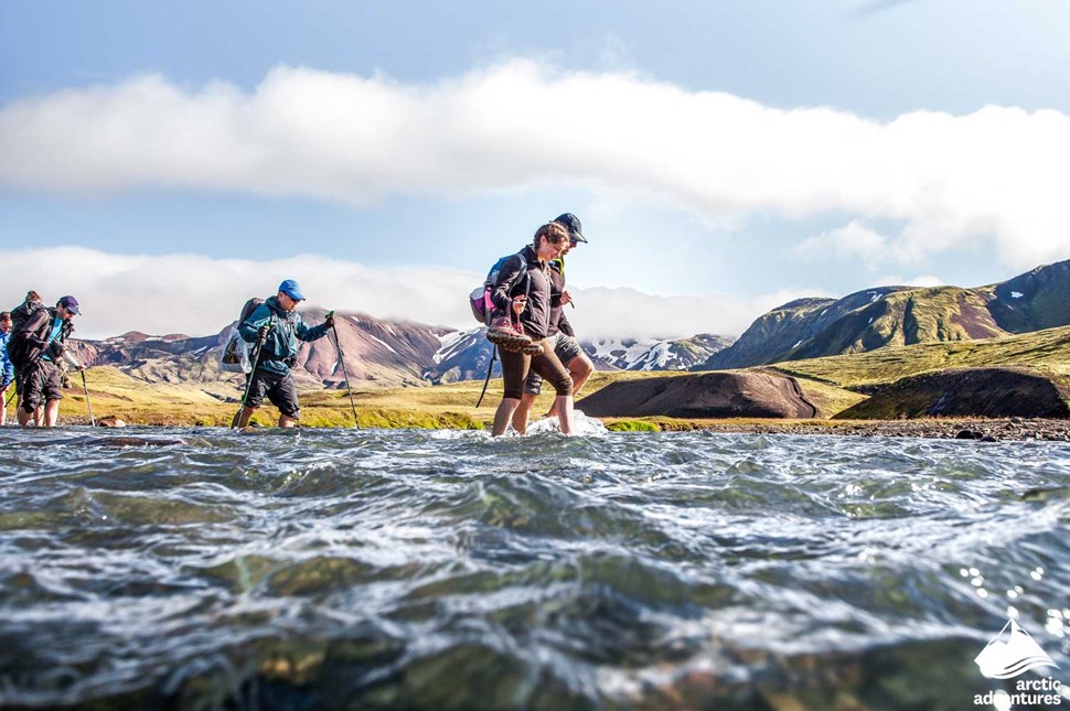 Small Group Crossing River by Foot in Iceland