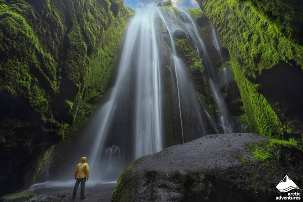 Man Standing by Hidden Waterfall in Iceland