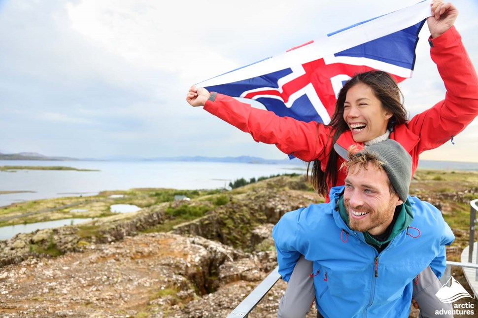 Excited Couple Holding Icelandic Flag