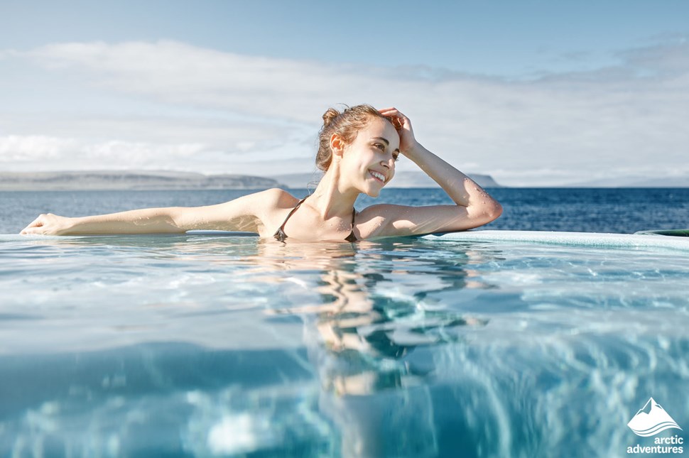 Woman Swimming in Pool by the Sea